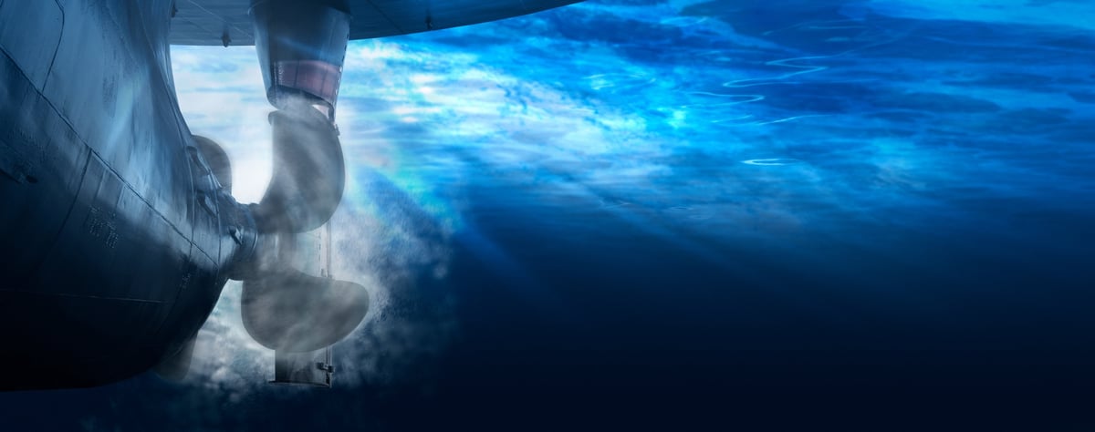 Underwater view of a large ship propeller and rudder