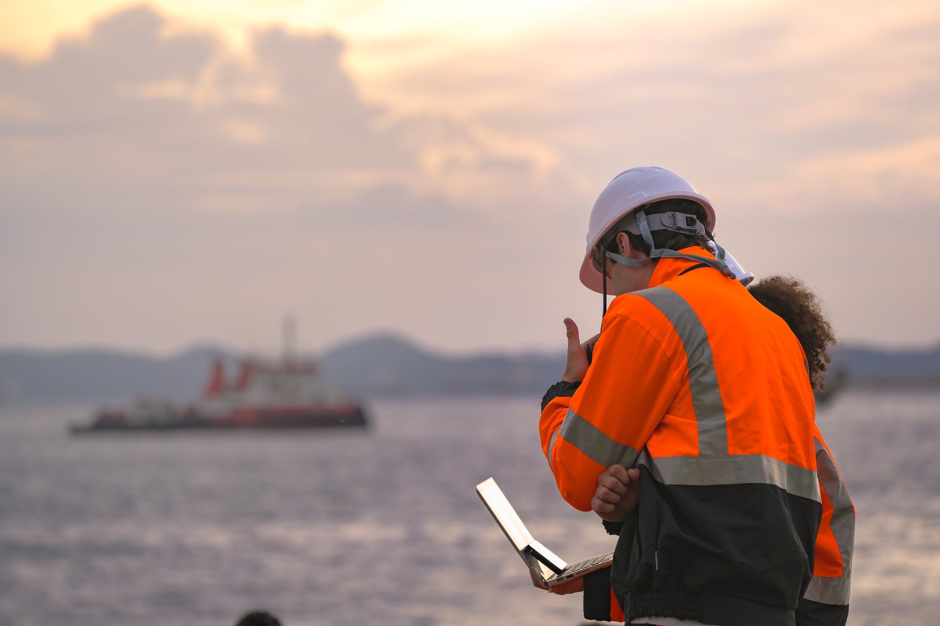 Maritime engineers with radio communication performing inspection