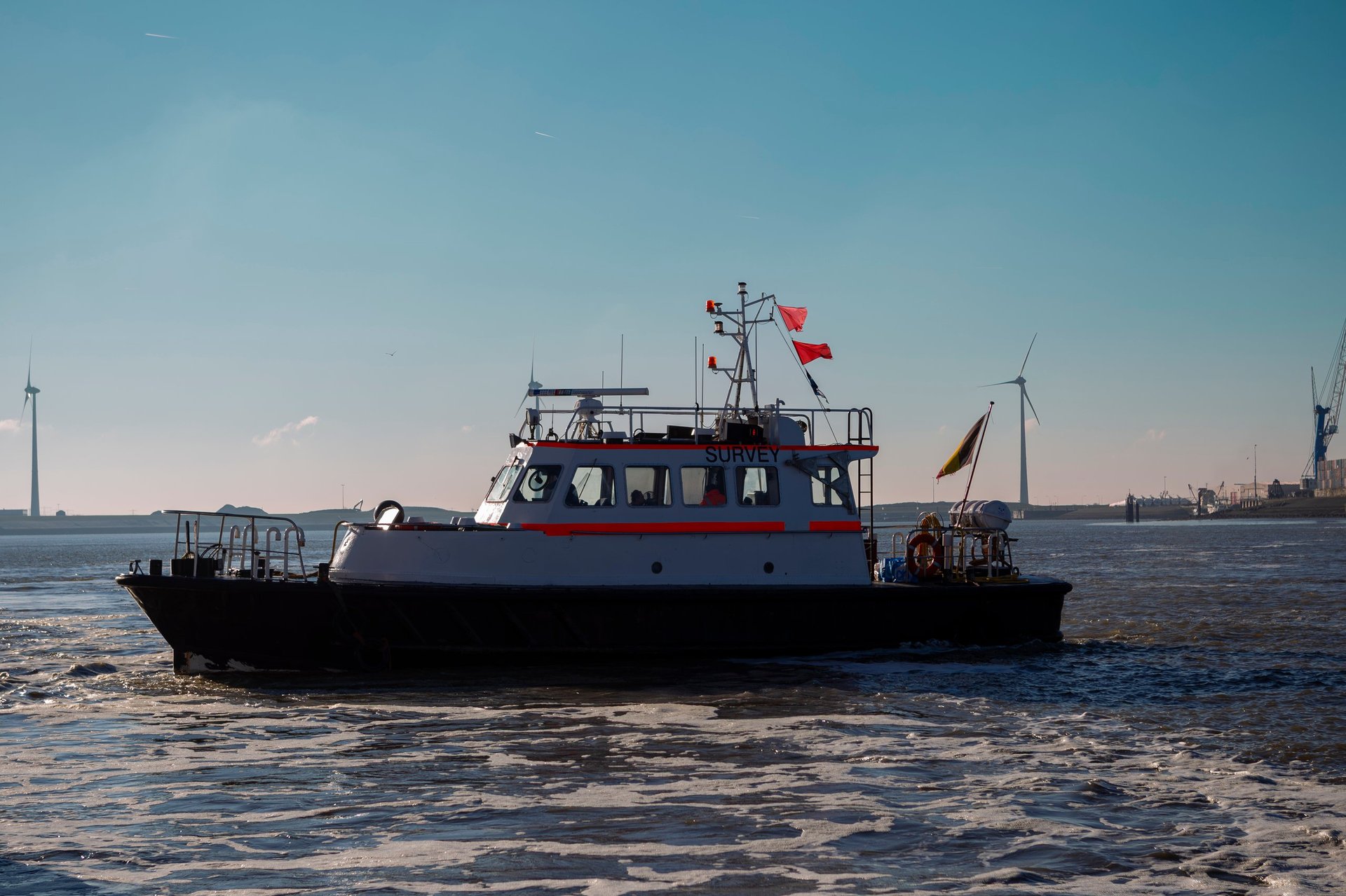 Survey vessel on the water with maritime equipment visible